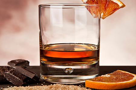 Photo of Cocktail Glass with Orange Slices and Chocolates