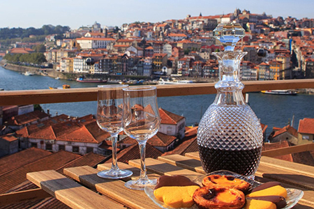 Photo of Fancy Porto Wine Flask with Two Glasses Overlooking the Douro River